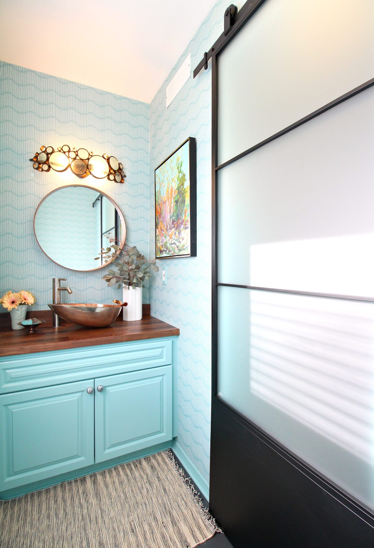 Turquoise Powder Room Makeover with Turquoise Vanity, Turquoise Sprigs on Ocean Wallpaper from Spoonflower, Walnut KARBLY Counter and Stockholm Mirror from IKEA, Handmade Copper Sink and Original Artwork