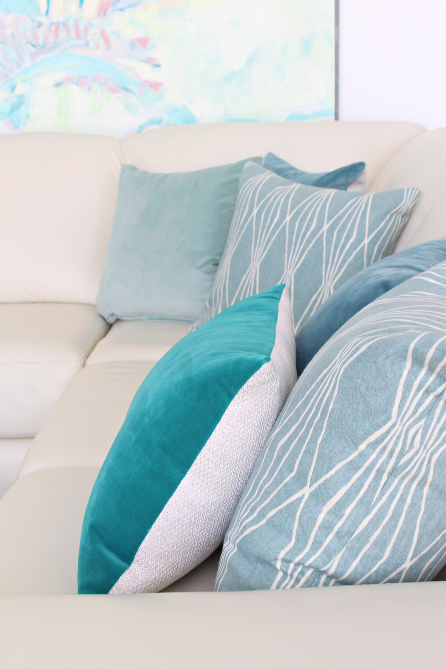 Spring pillows on cream leather sofa